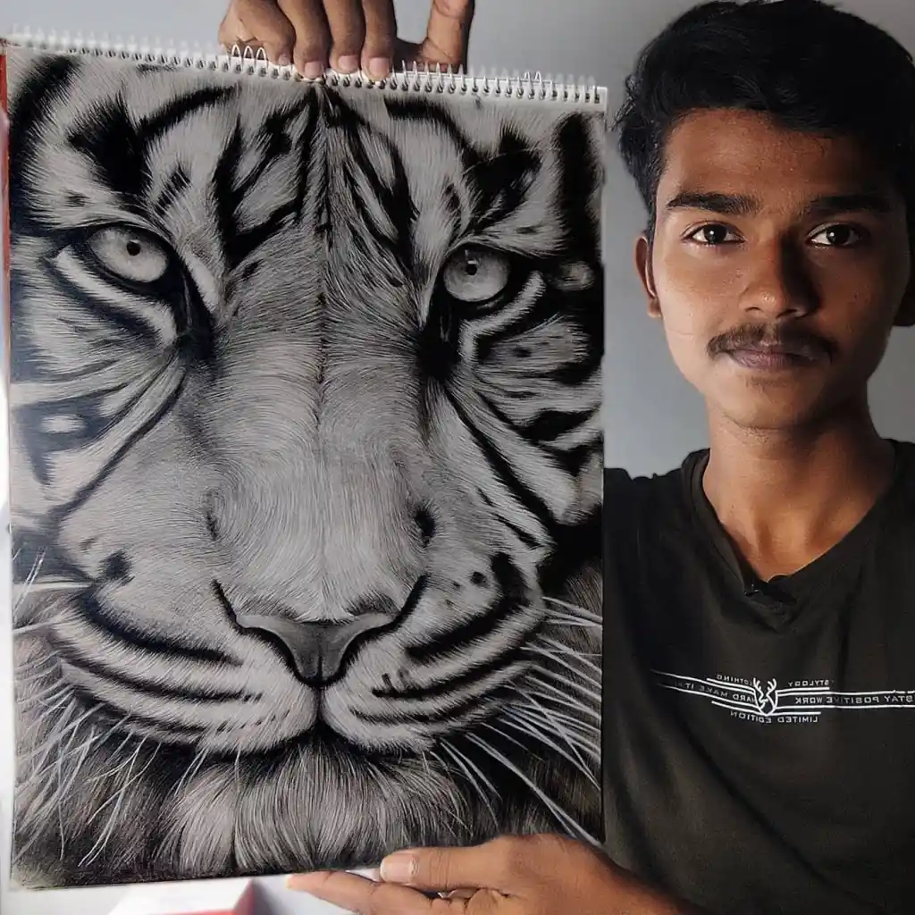 Me holding up one of my drawing of a tiger portrait drawn with charcoal